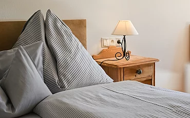 The cozy bed in the Studio room of the main building at the Pechtlgut in Lofer