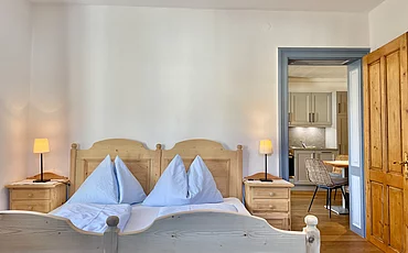 A cozy bed at the Cozy Country House at the Pechtlgut in Lofer